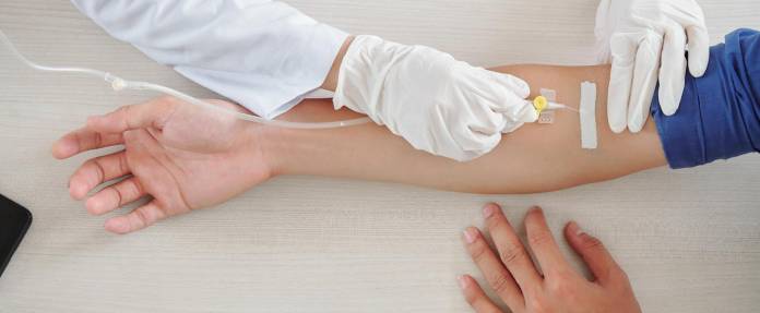 Mann erhält Infusion in den Arm